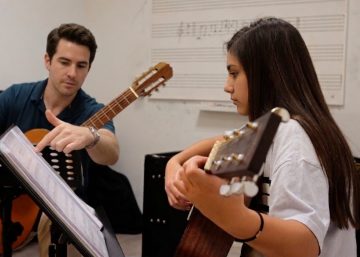 Niña aprendiendo música durante una actividad extraescolar en una escuela de música.